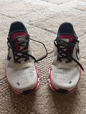 On Running Women’s CloudMonster Athletic Trainers in White with Red Accents